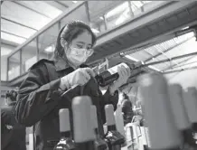  ?? XINHUA ?? An employee checks wine samples at a chateau in the Ningxia Hui autonomous region on April 10.