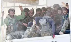  ?? — AFP ?? SDF fighters gesture the victory sign as they come back from the frontline in the IS group’s last remaining position in the village of Baghouz on Tuesday.