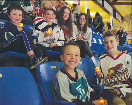  ?? BARB AGUIAR/Westside Weekly ?? Nolan and his brother Oliver Benson as well as Mason Casarso, Myles Benson, his sister Ellie and mom Carin Benson were in the stands at Royal LePage Place with their candles to support Humboldt.The three Benson boys are growing up playing hockey and...