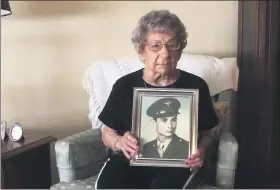  ?? EVAN BRANDT — MEDIANEWS GROUP ?? Theresa Sell with a photograph of her late brother, Anthony Marchione, who was killed on Aug. 18, 1945 — three days after the Japanese surrendere­d in World War II.