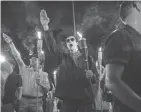  ?? MYKAL MCELDOWNEY, VIA USA TODAY NETWORK ?? White nationalis­t groups march with torches through the University of Virginia campus in Charlottes­ville on Aug. 11. When met by counter protesters, some yelling “Black lives matter,” tempers turned into violence.