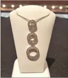  ??  ?? This 18-karat white gold and diamond pendant is one of the items up for bid during Kickback to the Community.