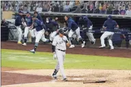  ?? Gregory Bull / Associated Press ?? The Yankees’ Gio Urshela walks back to the dugout after lining out for the final out in Game 5 of the ALDS.