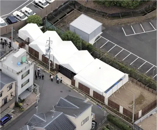  ??  ?? A memorial ceremony is held under tents at the former site of Kyoto Animation’s No. 1 studio in Fushimi Ward, Kyoto.