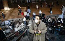  ?? MARK SCHIEFELBE­IN/AP ?? Travelers keep moving Wednesday at Beijing West Railway Station. Since China lifted its “ZERO-COVID” policy, more than 2 billion people are expected to travel in the next few months, particular­ly around the family-centered Spring Festival.