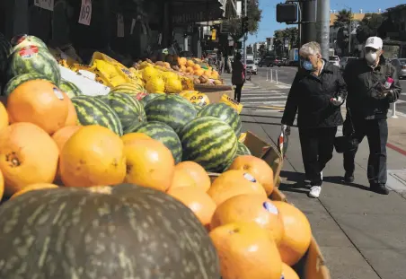  ?? Santiago Mejia / The Chronicle ?? Above: California­ns’ widespread wearing of masks is a key reason infections have stabilized in the state, experts say.