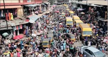  ?? PHOTO: REUTERS ?? People crowd a street in the central business district in Nigeria’s commercial capital Lagos, but the country’s economy is struggling to rebound from its worst slump in 25 years.