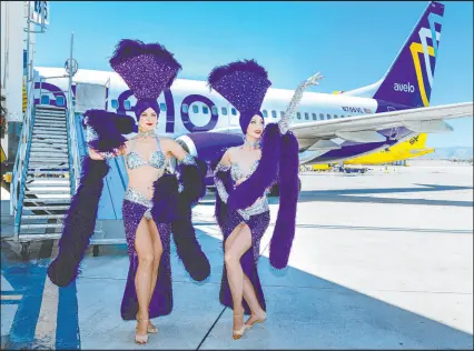  ?? L.E. Baskow Las Vegas Review-journal @Left_eye_images ?? Showgirls Tara Taylor, left, and Sisha Stowell on the tarmac in September as Avelo Airlines starts new nonstop destinatio­ns at Harry Reid Internatio­nal Airport.