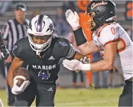  ?? STAFF PHOTO BY ROBIN RUDD ?? Marion County’s Sam Pickett carries the ball for a long gain during Friday night’s home game against Cascade in Jasper, Tenn.