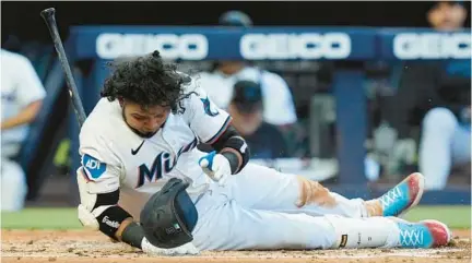  ?? MARTA LAVANDIER/AP ?? The Marlins’ Luis Arraez falls to avoid a close pitch during the second inning Monday against the Giants in Miami.