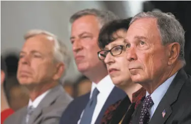  ?? Drew Angerer / Getty Images ?? Former New York City Mayor Michael Bloomberg (right) helped get the school started with a competitio­n in 2011. Bloomberg, a billionair­e, made his fortune selling innovative data terminals to Wall Street.