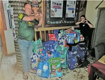  ?? Picture: SUPPLIED ?? HELPING HANDS: Geoff Cowley, owner of the Route 72 Saloon in Port Alfred, with manager Tyler Martin standing among the food donations collected for the local SPCA.