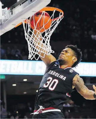  ?? KEVIN C. COX/GETTY IMAGES. ?? South Carolina Gamecocks forward Chris Silva dunks the ball in the second half against the Duke Blue Devils on Sunday in Greenville, S.C. Silva had 17 points and 10 rebounds in the 88-81 win.