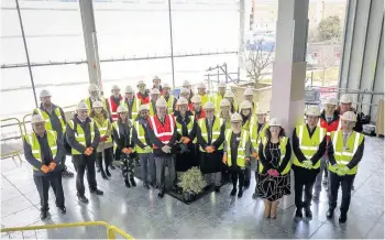  ??  ?? > Willmott Dixon staff with City University students in the new Curzon B extension