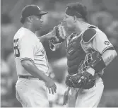  ?? TODD KIRKLAND/GETTY ?? The Yankees’ Wandy Peralta, left and Gary Sanchez celebrate a 5-4 victory over the Braves on Tuesday at Truist Park in Atlanta.