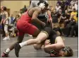  ?? JENNIFER FORBUS — FOR THE MORNING JOURNAL ?? Elyria’s Bryce Allison competes against St. Edward’s Richard Delsanter in the 120-pound weight class for a district title.