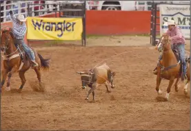  ?? NWA Democrat-Gazette/BEN GOFF @NWABENGOFF ?? Cody Heflin (left) and Thompson Berryhill take their turn in the team roping event Friday during the third night of the 73rd annual Rodeo of the Ozarks at Parsons Stadium in Springdale. Heflin and Berryhill were the only team of the night to get a clean rope, with a time of 8.0 seconds.