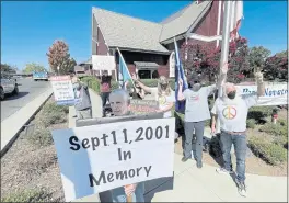  ??  ?? Members of Peace Novato held a vigil in front of Novato City Hall on Saturday in memory of those who died in the Sept, 11, 2001 attacks.
