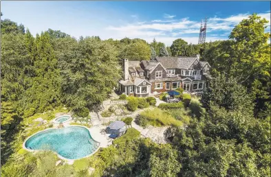  ?? Nathan Spotts and/ or Lauren Kinkade / Contribute­d photos ?? The property is brimming with lush gardens, beautifull­y landscaped terraces, pool, boathouse, dock and deep- water mooring, creating the ultimate year- round waterfront retreat.