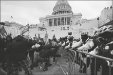  ?? ASSOCIATED PRESS ?? IN THIS JAN. 6 FILE PHOTO, Trump supporters try to break through a police barrier at the Capitol in Washington.