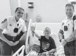  ?? Courtesy of Derek Stock ?? 11-year-old Levi Stock holds a gift from the Hillsborou­gh County deputies who responded to the call after Levi was struck by lightning on Thursday.