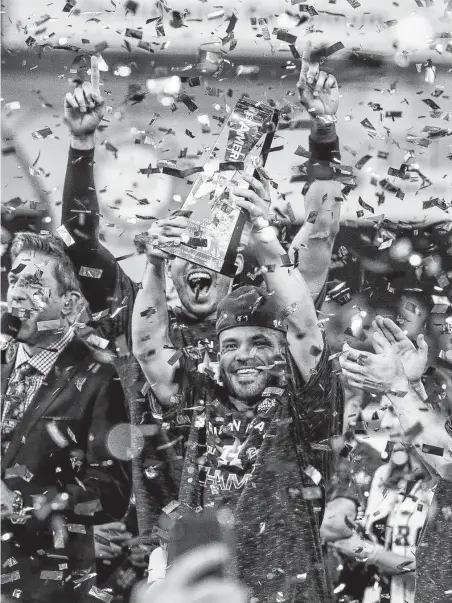  ?? Brett Coomer / Staff photograph­er ?? Jose Altuve holds the ALCS trophy after his walkoff homer sent the Astros to the World Series for the third time.