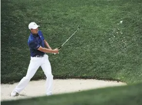  ??  ?? Jordan Spieth takes a shot out of the bunker at the U.S. Open Thursday. The defending champion was unable to finish because of the weather.