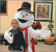  ??  ?? Houston Marshall, 6, finds Blizzard the snowman at Calvary’s Sunday evening Christmas Rhythm service.