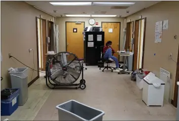  ?? JOHN LOCHER — THE ASSOCIATED PRESS ?? A health care worker sits in a hurricane-damaged emergency room at Leonard J. Chabert Medical Center in Houma, La., on Friday.