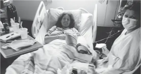  ??  ?? Licia Corbella lies in a hospital bed in isolation at Rockyview Hospital with nurse Sherolyn as she was undergoing breast cancer treatment. She describes this photo as “leading into one of the worst nights of my life.”