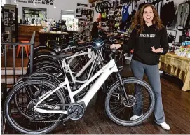  ?? Tyler Sizemore/Hearst Connecticu­t Media ?? Owner Julie Gabay shows the Specialize­d Turbo Vado e-bike for sale at Pacific Cycling & Triathlon in Stamford recently.