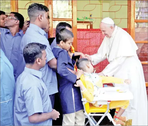  ??  ?? Francis meets with staff members and sick people at the Mother Teresa House clinic in Dhaka’s Tejgaon neighbourh­ood. — AFP photo