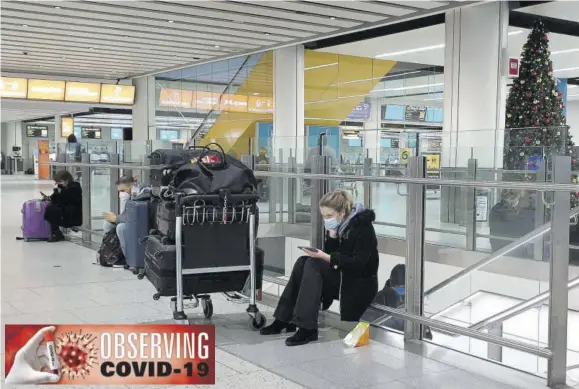  ?? (Photo: Gareth Fuller/pa via AP) ?? Passengers wait at Gatwick Airport in West Sussex, England, yesterday. One by one, several European Union nations have banned flights from the UK and others are considerin­g similar action in a bid to block a new strain of coronaviru­s, sweeping across southern England, from establishi­ng a strong foothold on the continent.