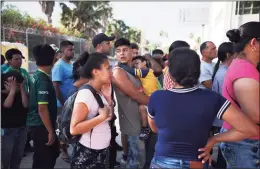  ?? Emilio Espejel / Associated Press file photo ?? In this July 31, 2019 photo, migrants line up in Matamoros, Mexico, for a meal donated by volunteers from the U.S., at the foot of the Puerta Mexico bridge that crosses to Brownsvill­e, Texas. Some asylum seekers were told by officials on Friday, that the U.S. government may reopen their cases and they would eventually be able to enter the U.S. to wait out the asylum process.