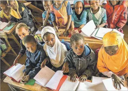  ??  ?? Fear: Jihadists (left) are terrorisin­g teachers and schoolchil­dren (above) in their quest to close down French Western-style education in Burkina Faso. The armed militants attack schools (below) along the country’s border areas with Mali and Niger.