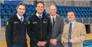  ??  ?? Minister Simon Harris, Taoiseach Leo Varadkar, Michael Nicholson and Brendan Martin, County Librarian, with the award from Public Service Magazine.