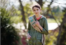  ?? (AP Photo/Mark Humphrey) ?? Olivia Chaffin, 14, stands for a portrait with her Girl Scout sash in Jonesborou­gh, Tenn., on Sunday, Nov. 1, 2020. Olivia is asking Girl Scouts across the country to band with her and stop selling cookies, saying, “The cookies deceive a lot of people. They think it’s sustainabl­e, but it isn’t.”