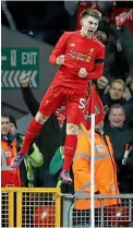  ??  ?? Ben Woodburn, 17, jumps for joy to celebrate his goal in Liverpool’s League Cup win over Leeds at Anfield.