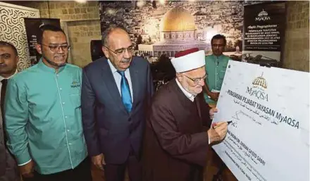  ?? [FOTO ABD RAHIM RAHMAT /BH] ?? Sheikh Ekrima merasmikan pejabat Yayasan MYAQSA sambil diiringi Duta Besar Palestin Ke Malaysia, Walid Abu Ali (tengah) dan Ketua Pegawai Eksekutif Yayasan MYAQSA, Dr Noorazman Mohd Samsuddin di Yayasan Myaqsa Putrajaya, baru-baru ini.