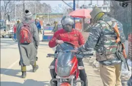  ?? PTI ?? A securityma­n stops a man on a bike in Srinagar on Thursday. Amid intelligen­ce inputs about presence of terrorists across the border, a multi-layered security apparatus has been put in place to ensure peaceful Republic Day celebratio­ns in Jammu and Kashmir.