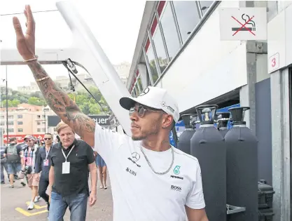  ??  ?? Mercedes’ Lewis Hamilton waves before the start of the second free practice session on Thursday.