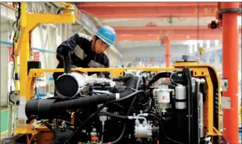  ?? YU FANGPING / FOR CHINA DAILY ?? A worker assembles an excavator in a plant of Qingdao Lovol Excavator Co Ltd in Qingdao, Shandong province.