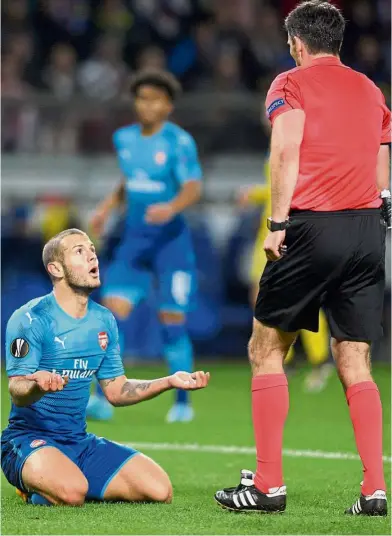  ?? — Reuters ?? I’m begging you: Arsenal’s Jack Wilshere arguing with referee Daniel Stefanski in the Europa League match against BATE Borisov in Barysaw, Belarus, on Thursday.