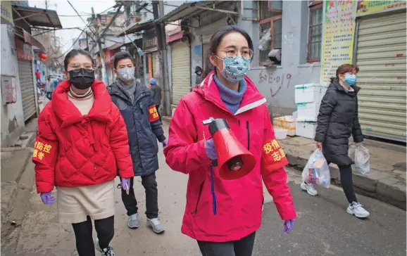  ?? Photo: Xinhua/Xiao Yijiu ?? Community workers use a speaker to publicise the informatio­n about prevention and control of the novel coronaviru­s at a street near the Yellow Crane Pavilion in Wuhan, central China’s Hubei Province, on February 7, 2020.