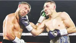 ??  ?? UNDISPUTED CHAMP – Unbeaten Teofimo Lopez, right, connects with a right uppercut against Ukraine’s Vasiliy Lomachenko in their world lightweigh­t unificatio­n title fight in Las Vegas yesterday. Lopez won via unanimous decision. (Top Rank photo)