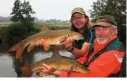  ??  ?? “Mine’s bigger” – a friendly barbel match.