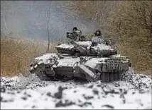  ?? Anatolii Stepanov AFP/Getty Images ?? A UKRAINIAN tank in the Donetsk region Wednesday. Russia has readily violated agreements with its neighbors.