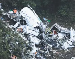  ??  ?? Rescue workers search through the wreckage of a chartered airplane that crashed in a mountainou­s area outside Medellin, Colombia, on Tuesday. The plane was carrying the Brazilian soccer club Chapecoens­e. Luis Benavides, The Associated Press