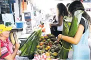  ??  ?? Una cliente compra hojas de bijao del Centro.