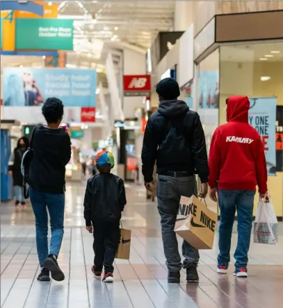  ?? Bloomberg ?? Customers carry Nike shopping bags at a mall in Anne Arundel County, Md., in early November.